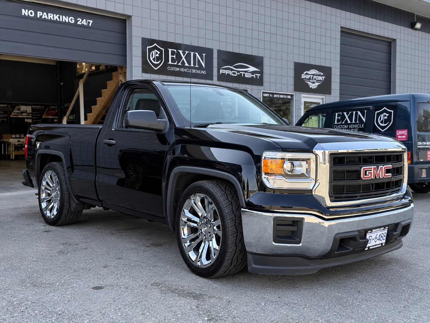 Black GMC pickup outside the EXIN workshop